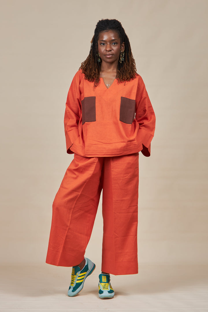 Orange Freestyle Top with a double coffee patch and matching wide cropped trousers.